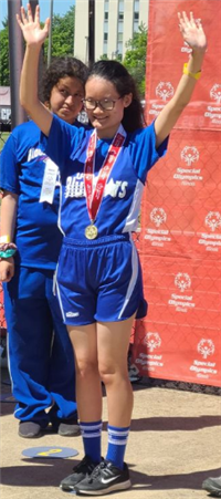 Blue Stars athlete raises hands above head 